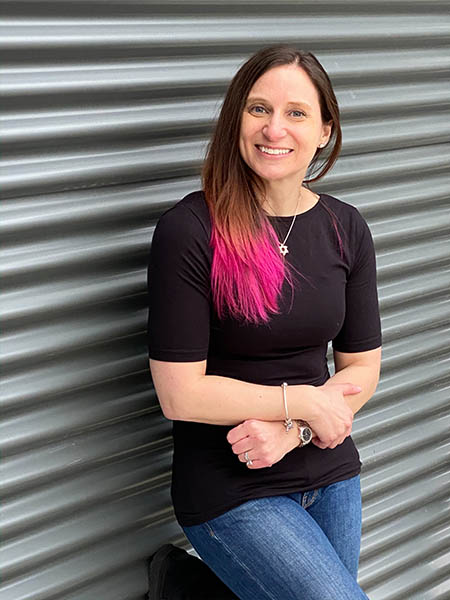 Jaime Slutzky leaning against a corugated metal wall.